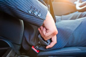 driver-in-business-suit-fastens-his-seat-himself-automobile-seat